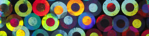 A vibrant and playful abstract background of colorful circles with centers filled with different colors.